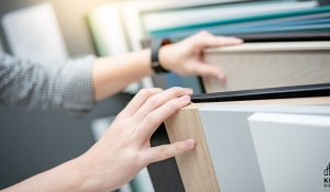 Hands of a Couple selecting cabinetry to show Design Options and Upgrades on a Budget