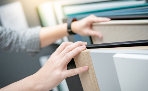 Hands of a Couple selecting cabinetry to show Design Options and Upgrades on a Budget