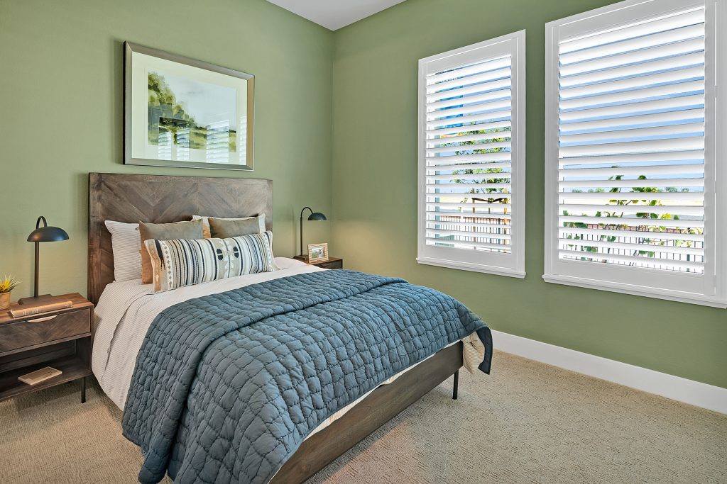 color of the year bedroom with green walls and two windows