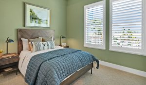 color of the year green bedroom with two large windows