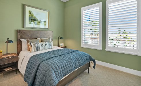 color of the year green bedroom with two large windows