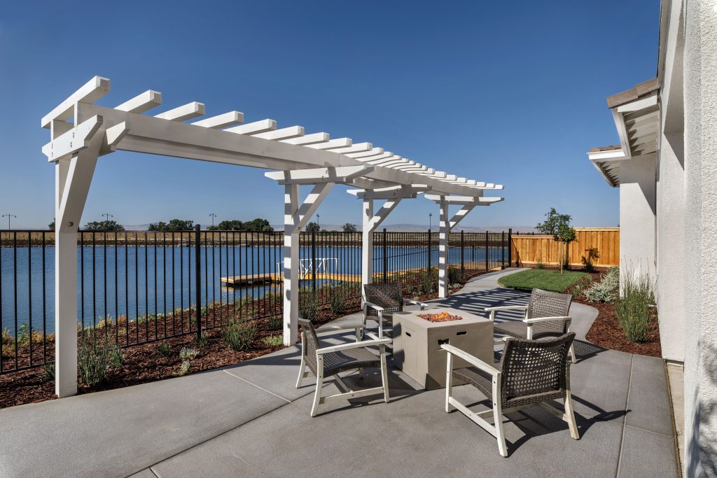 outdoor living space with pergola and waterfront views