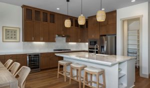 residence 2 kitchen at skye II at river islands with white island and wooden cabinetry